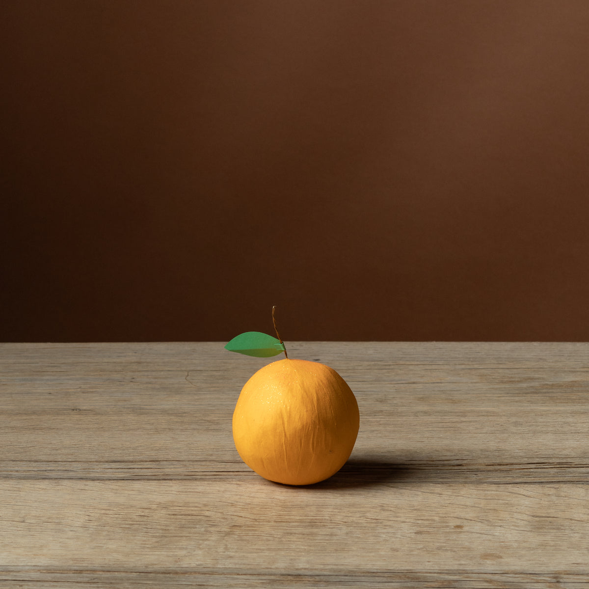 Deluxe Citrus Surprise Ball, orange crepe paper with green paper leaf